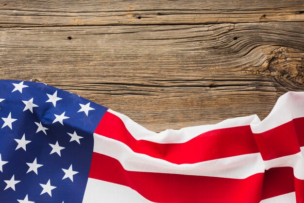 Flat lay of american flag on wood with copy space