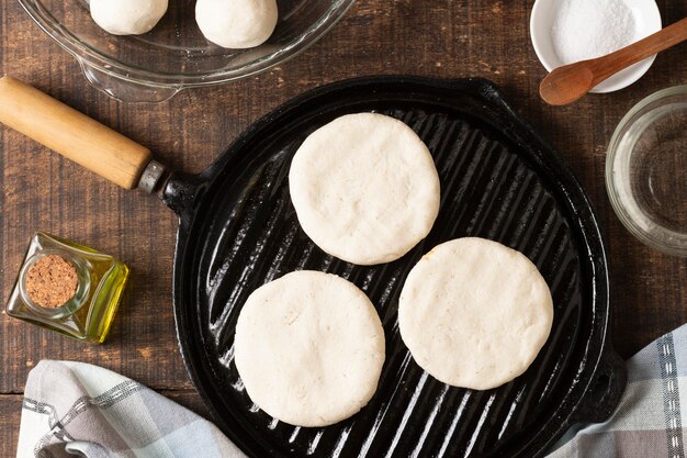 Flat lay arepas dough on wooden board