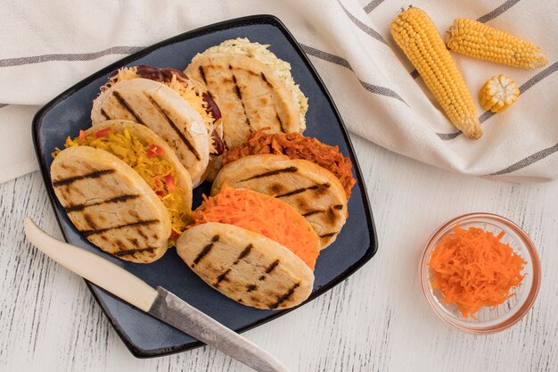 Flat lay arepas on plate with corn