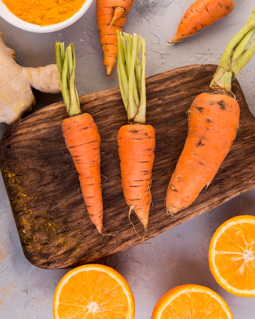 Flat lay arrangement of carrots and oranges