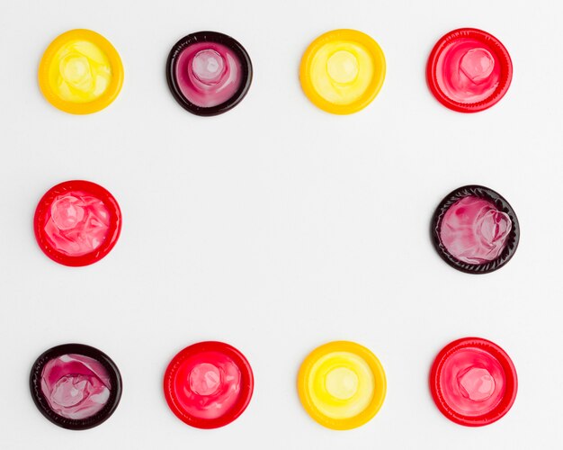 Flat lay arrangement of colorful condoms with copy space