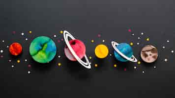 Free photo flat lay arrangement of creative paper planets