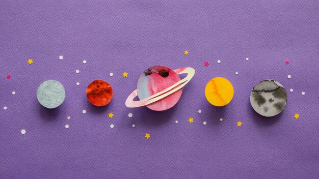 Flat lay arrangement of creative paper planets