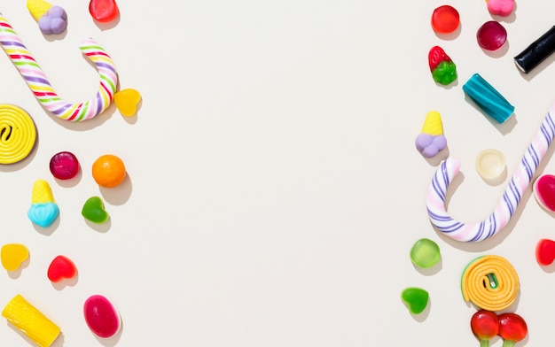 Flat lay arrangement of different colored candies with copy space