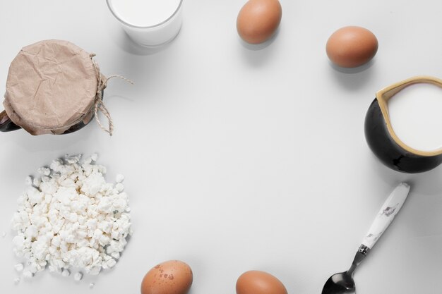 Flat lay arrangement of different ingredients on white background with copy space