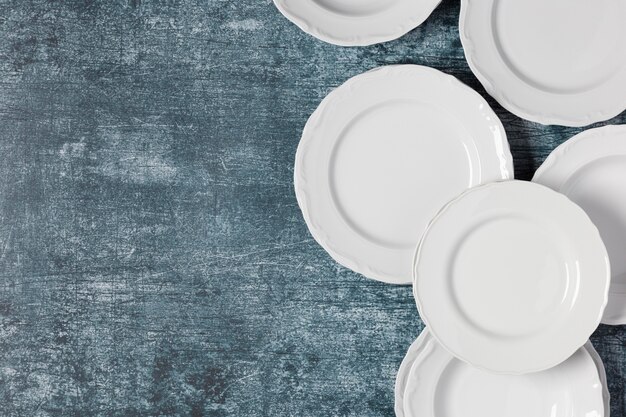 Flat lay arrangement of different plates with copy space