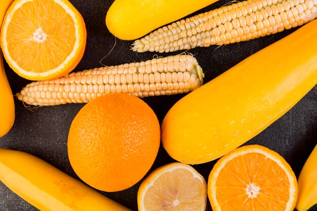 Flat lay arrangement of maize and oranges