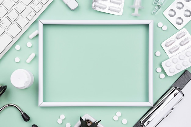 Flat lay arrangement of medical objects with empty frame