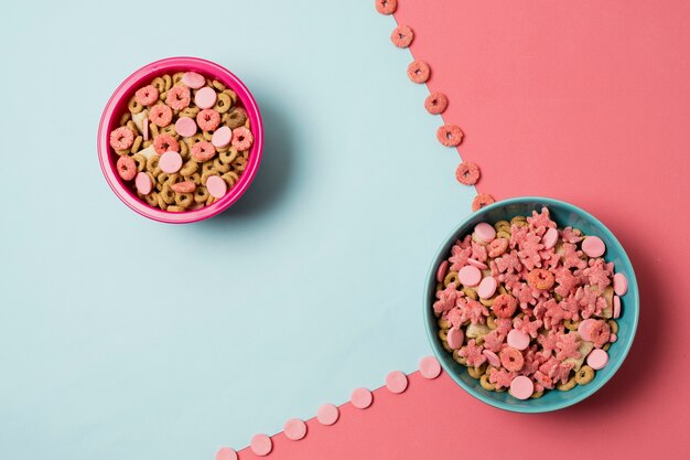 Flat lay arrangement with cereal bowls and colorful background