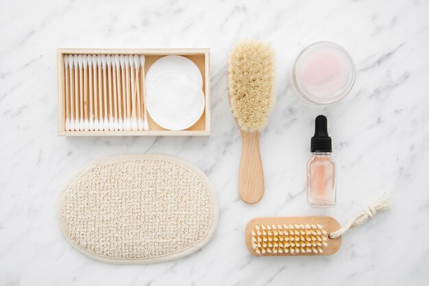 Flat lay arrangement with cosmetics on marble table