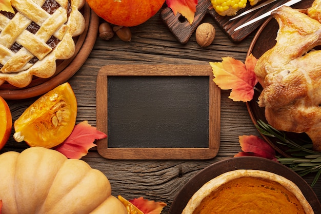 Flat lay arrangement with delicious thanksgiving food and frame