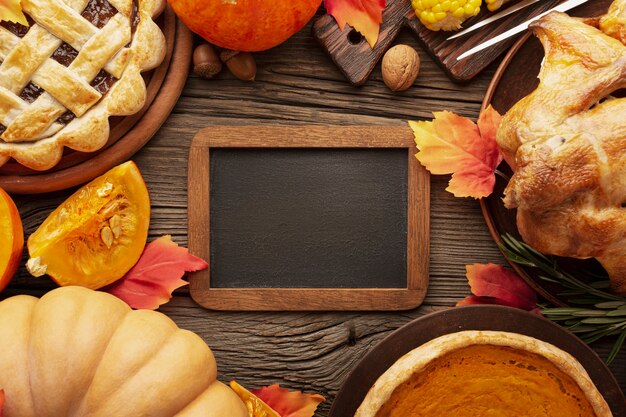 Flat lay arrangement with delicious thanksgiving food and frame