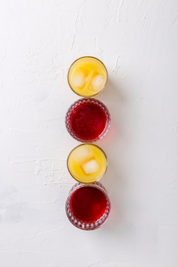 Free Photo flat lay arrangement with different colored drinks