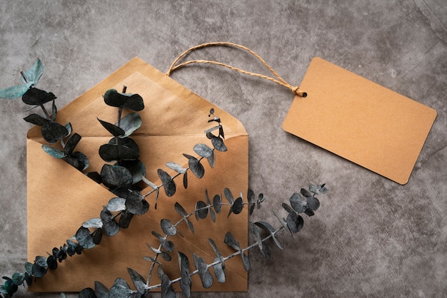 Free photo flat lay arrangement with envelope and twig