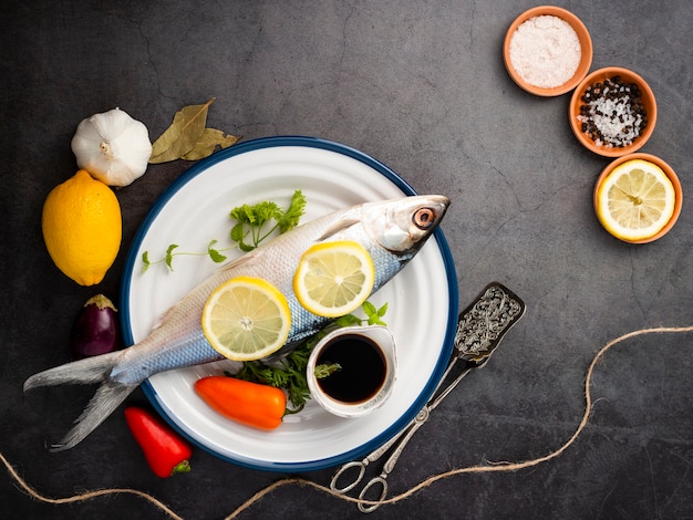 Flat lay arrangement with fish and pepper