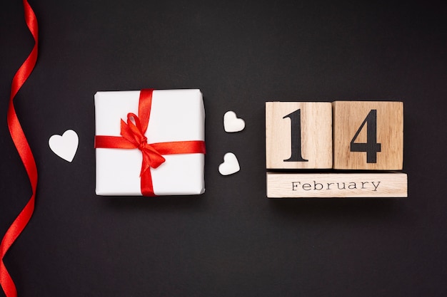 Flat lay arrangement with gift on black background