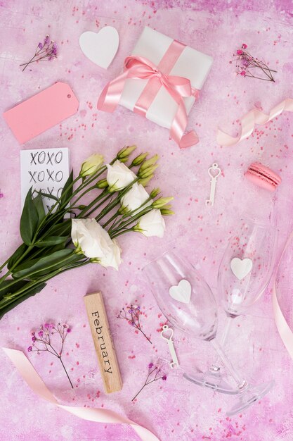 Flat lay arrangement with gifts on pink background