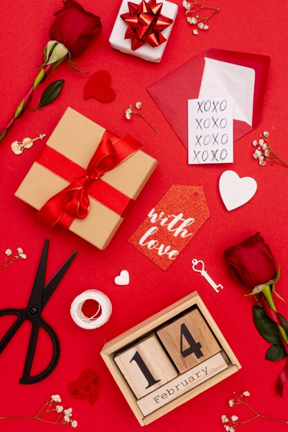 Flat lay arrangement with gifts on red background