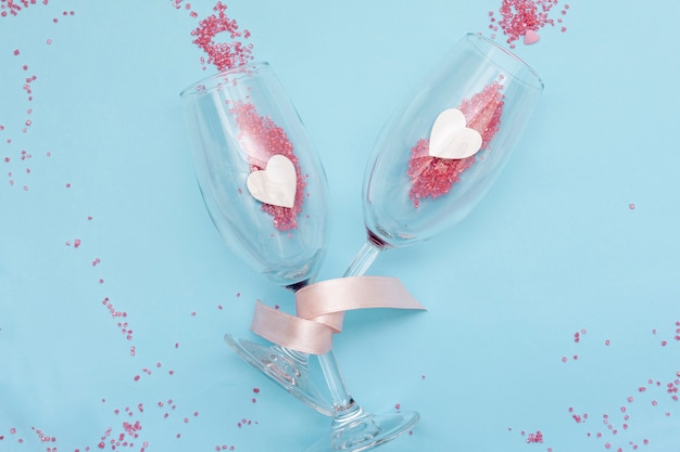 Flat lay arrangement with glasses on blue background