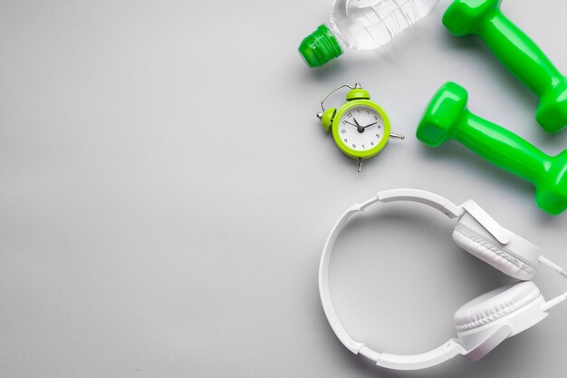 Flat lay arrangement with green dumbbells and copy-space