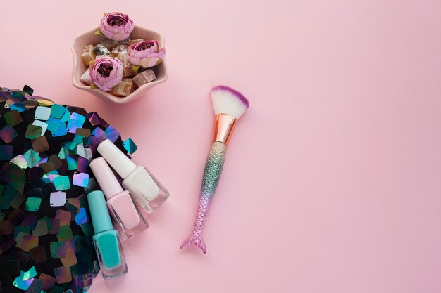 Flat lay arrangement with nail polish and make-up brush