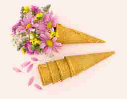 Free photo flat lay arrangement with pink daisies and cones