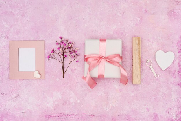 Flat lay arrangement with present on pink background