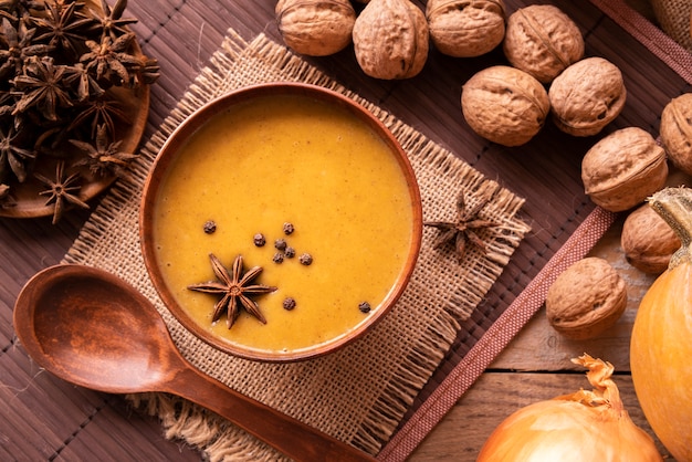 Free photo flat lay arrangement with pumpkin soup and nuts