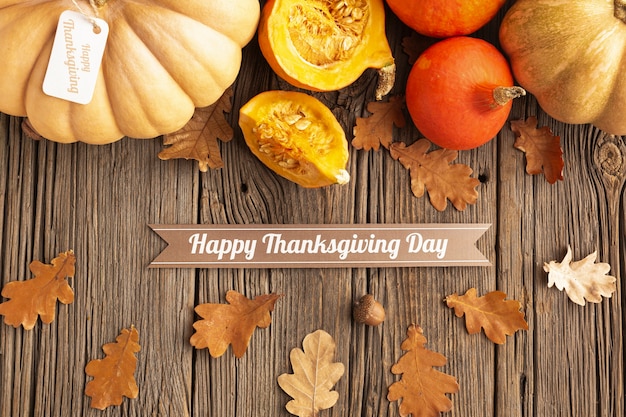 Flat lay arrangement with pumpkins on wooden background