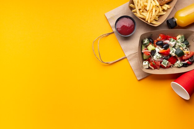 Flat lay arrangement with salad box and sauce