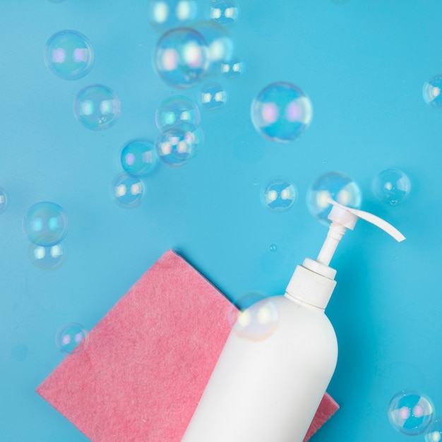 Free photo flat lay arrangement with soap bottle and bubbles