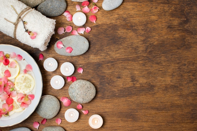 Flat lay arrangement with spa items on wooden background