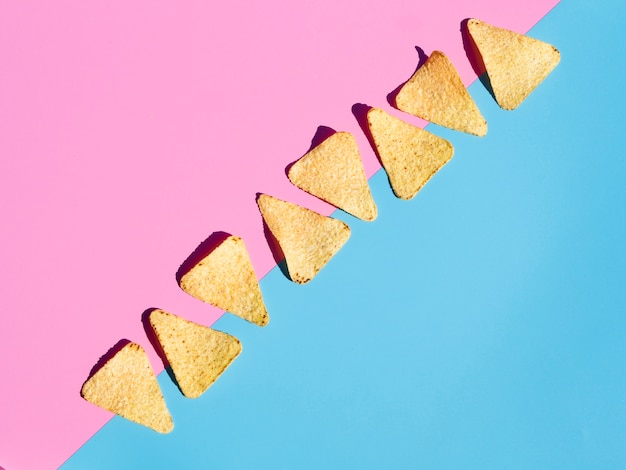 Flat lay arrangement with tortilla on pink and blue background