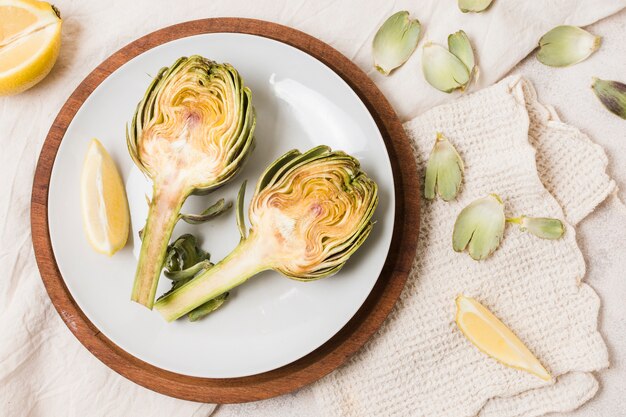 Flat lay of artichoke on plate with cloth