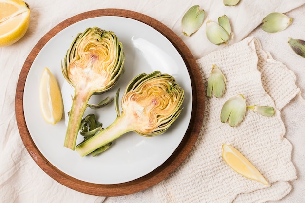 Flat lay of artichoke on plate with cloth