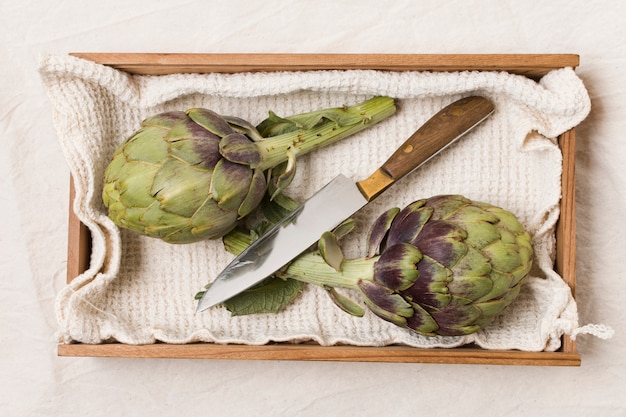 Flat lay of artichokes and knife