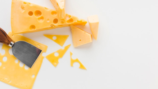 Flat lay assortment of cheese and cheese knife with copy space