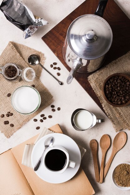 Flat lay assortment of coffee with grinder and milk