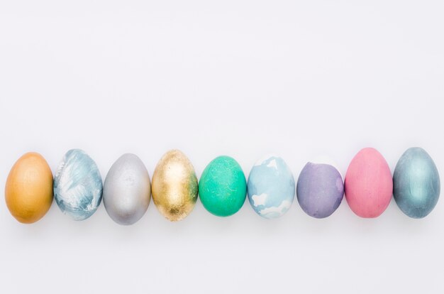 Flat lay of assortment of colorfully painted easter eggs