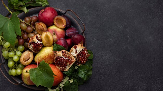 Flat lay assortment of delicious autumn fruits with copy space