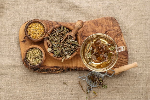 Flat lay assortment of dried plants in cup of teas