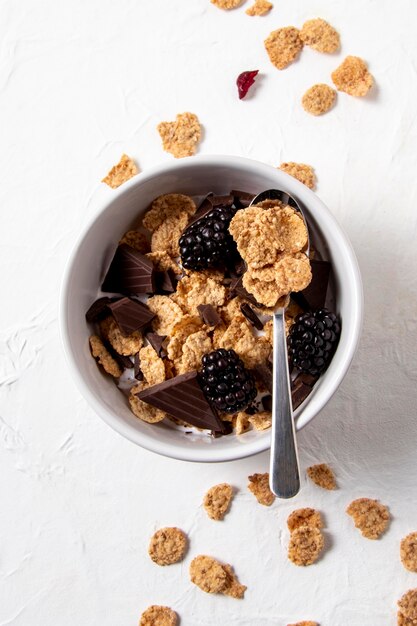 Flat lay assortment of healthy bowl cereals with chocolate