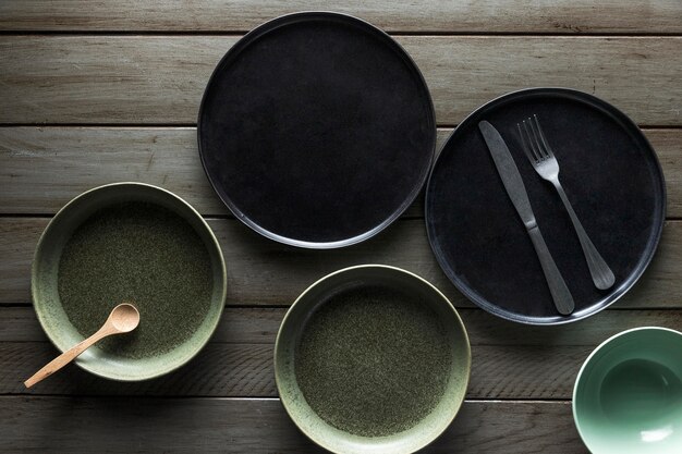 Flat lay of assortment of plates with cutlery