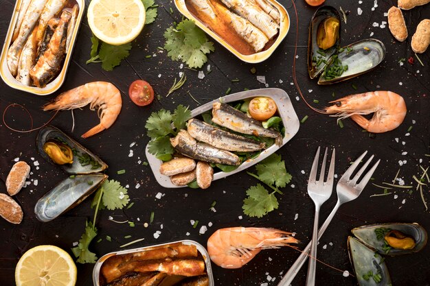 Flat lay of assortment of seafood with cutlery