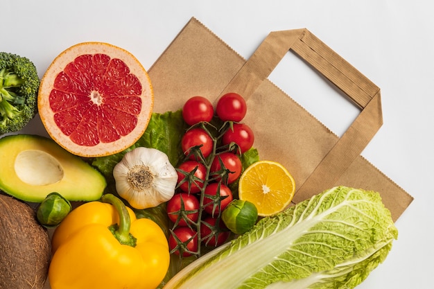 Flat lay of assortment of vegetables with paper bag