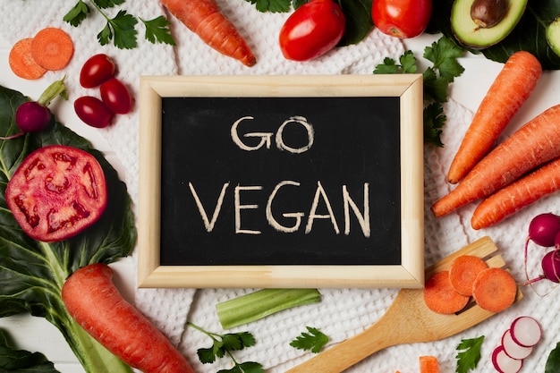 Flat lay assortment with blackboard and vegetables