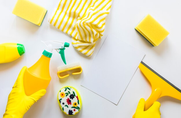 Flat lay assortment with cleaning products on white background