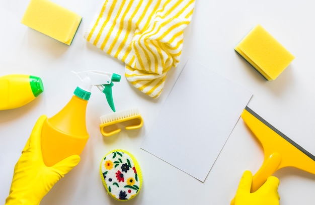 Flat lay assortment with cleaning products on white background