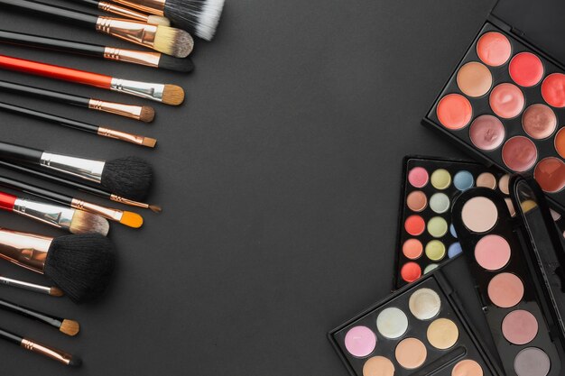 Flat lay assortment with make-up brushes and palettes