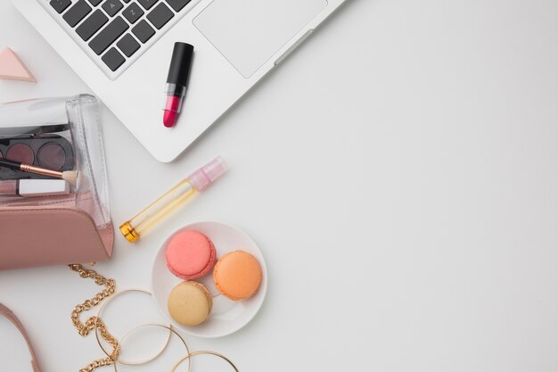 Flat lay assortment with make-up and laptop